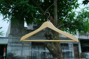 Photo of a wooden clothes hanger on a hanger