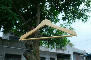 Photo of a wooden clothes hanger on a hanger