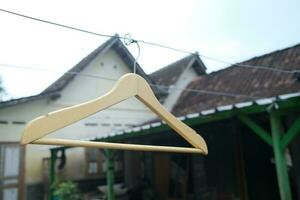 Photo of a wooden clothes hanger on a hanger