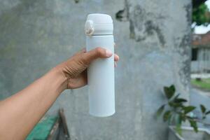 photo of a white drinking bowl held in hand