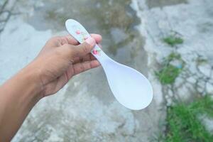 Photo of a white spoon held in hand