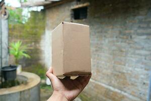 blank brown cardboard photo with hand