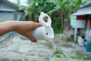 photo of a white drinking bowl held in hand