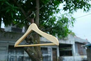 Photo of a wooden clothes hanger on a hanger