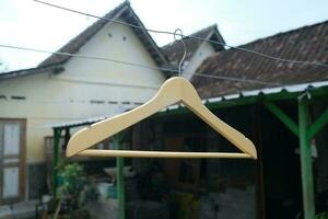 Photo of a wooden clothes hanger on a hanger