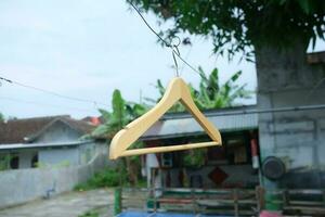 Photo of a wooden clothes hanger on a hanger