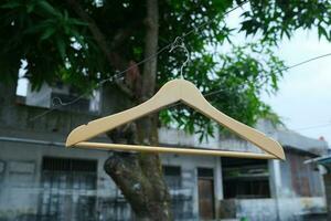 Photo of a wooden clothes hanger on a hanger