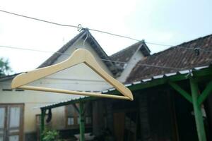 Photo of a wooden clothes hanger on a hanger