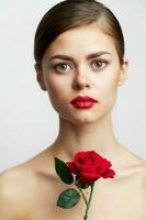 Girl with bare shoulders model holding a rose bright makeup photo