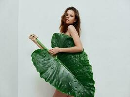 woman with green palm leaf glamor nude body photo