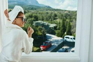 stylish woman posing against the backdrop of mountains on the balcony architecture unaltered photo