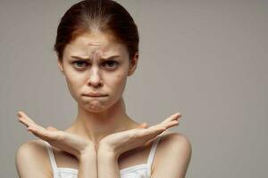 beautiful woman in a white t-shirt pimples on the face close-up photo