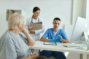 elderly woman patient doctor assistant in hospital photo