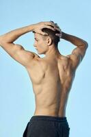 bodybuilder with pumped up arm muscles naked back back view photo