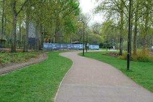 Low Angle View of Willen Lake Park with Local and Tourist Public Enjoying the Beauty of Lake and Park by Walking Around with Their Families. Footage Was Captured on 09-April-2023 at Milton Keynes UK photo