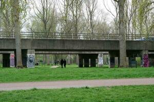 Low Angle View of Willen Lake Park with Local and Tourist Public Enjoying the Beauty of Lake and Park by Walking Around with Their Families. Footage Was Captured on 09-April-2023 at Milton Keynes UK photo