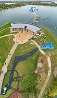 Low Angle View of Willen Lake Park with Local and Tourist Public Enjoying the Beauty of Lake and Park by Walking Around with Their Families. Footage Was Captured on 09-April-2023 at Milton Keynes UK photo