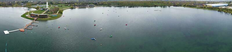 Low Angle View of Willen Lake Park with Local and Tourist Public Enjoying the Beauty of Lake and Park by Walking Around with Their Families. Footage Was Captured on 09-April-2023 at Milton Keynes UK photo