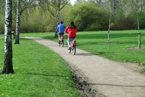 Low Angle View of Willen Lake Park with Local and Tourist Public Enjoying the Beauty of Lake and Park by Walking Around with Their Families. Footage Was Captured on 09-April-2023 at Milton Keynes UK photo