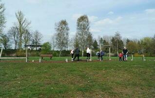 Low Angle View of Willen Lake Park with Local and Tourist Public Enjoying the Beauty of Lake and Park by Walking Around with Their Families. Footage Was Captured on 09-April-2023 at Milton Keynes UK photo