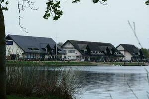 Low Angle View of Willen Lake Park with Local and Tourist Public Enjoying the Beauty of Lake and Park by Walking Around with Their Families. Footage Was Captured on 09-April-2023 at Milton Keynes UK photo