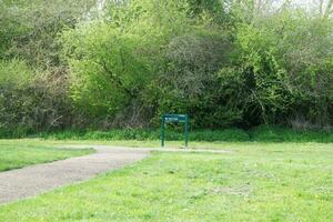 Low Angle View of Willen Lake Park with Local and Tourist Public Enjoying the Beauty of Lake and Park by Walking Around with Their Families. Footage Was Captured on 09-April-2023 at Milton Keynes UK photo