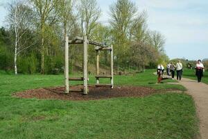 Low Angle View of Willen Lake Park with Local and Tourist Public Enjoying the Beauty of Lake and Park by Walking Around with Their Families. Footage Was Captured on 09-April-2023 at Milton Keynes UK photo