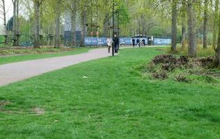 Low Angle View of Willen Lake Park with Local and Tourist Public Enjoying the Beauty of Lake and Park by Walking Around with Their Families. Footage Was Captured on 09-April-2023 at Milton Keynes UK photo