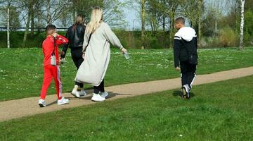 Low Angle View of Willen Lake Park with Local and Tourist Public Enjoying the Beauty of Lake and Park by Walking Around with Their Families. Footage Was Captured on 09-April-2023 at Milton Keynes UK photo