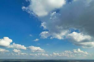 Aerial View of British Countryside and Paragliders while they are Flying High in the Sky. Drone's Camera Footage. photo