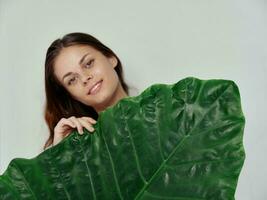 pretty woman green palm leaf exotic light background photo