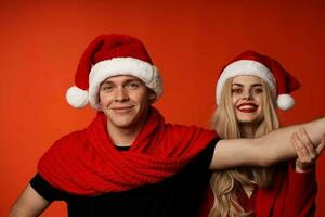 young couple in New Year's clothes Christmas holiday red background photo