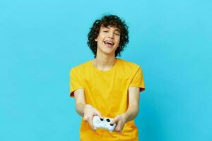 gamer plays with joystick in yellow t-shirts technologies photo