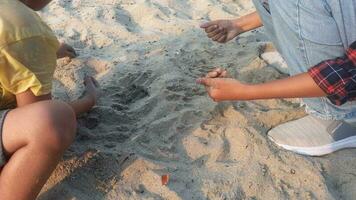 Two girls are playing in the sand photo