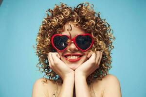 Emotional blonde glamor on an isolated blue background photo