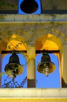 Greek orthodox church bells lit at night in a church in Preveza in Greece photo