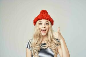 blonde in a striped T-shirt Red Hat posing Studio photo