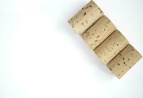 Corks on the diagonal isolated on a white background shot from above. photo