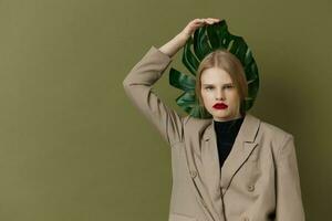 portrait of a woman green palm leaf coat bright makeup studio model unaltered photo