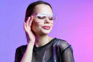 woman in fashionable clothes makeup glasses studio disco posing photo