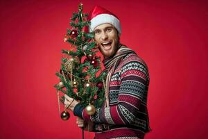 man with decorated christmas tree holiday christmas fun red background photo