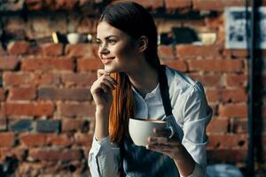 woman with a cup of coffee Near the table waiter service work professionals photo