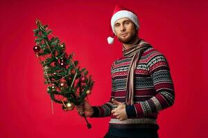 emotional man Christmas tree toys New year red background photo