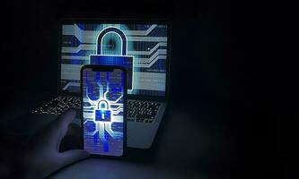 Locked laptop and smartphone screen. Cyber security concept. Hacking and login attempt. Phone lock to protect from cyber scam. Phishing, cybersecurity danger or ransomware attack photo