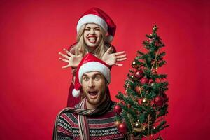 young couple christmas holiday fun romance red background photo
