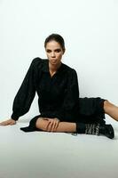 woman in black dress sitting on the floor fashion glamor photo