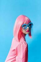 woman in blue glasses wears a pink wig Lifestyle posing photo