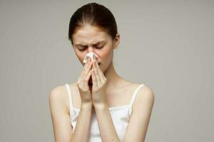 sick woman in white t-shirt with a scarf isolated background photo