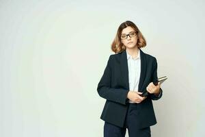 woman in black suit wearing glasses documents entrepreneur work photo