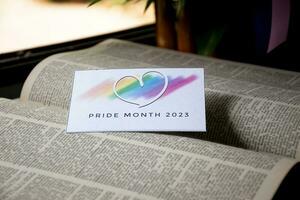 'Pride Month 2023' card on opened book, concept for calling out to respect gender diversity and to invite all people to enjoy LGBTQ events celebrations around the world in pride month. photo